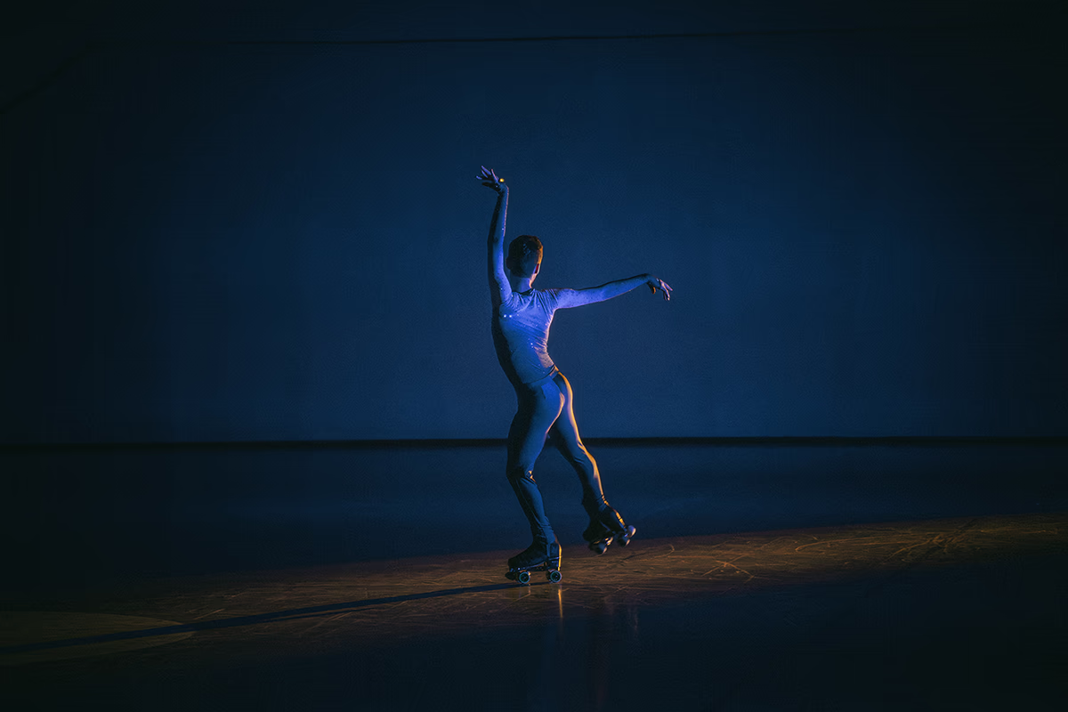 Photo of a male artistic skater during a show.