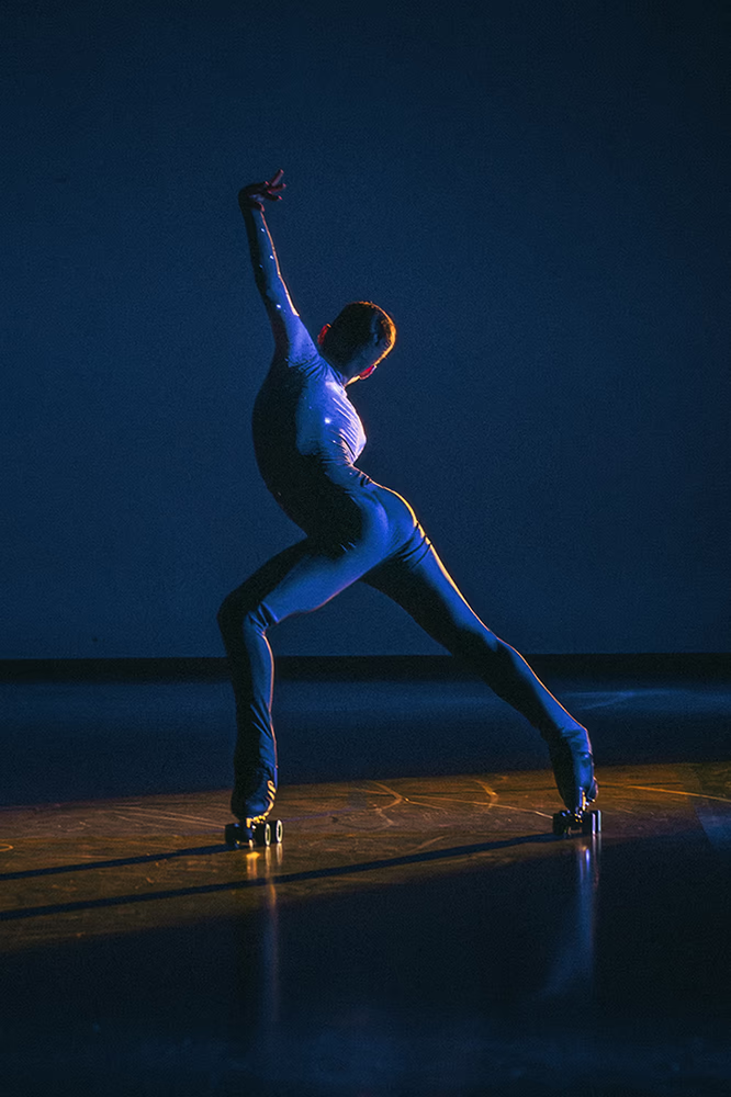 Photo of a male artistic skater during a show.